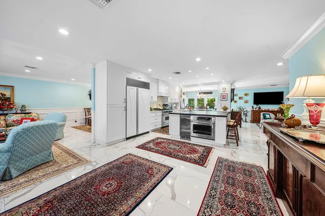 a living room with furniture and a dining room