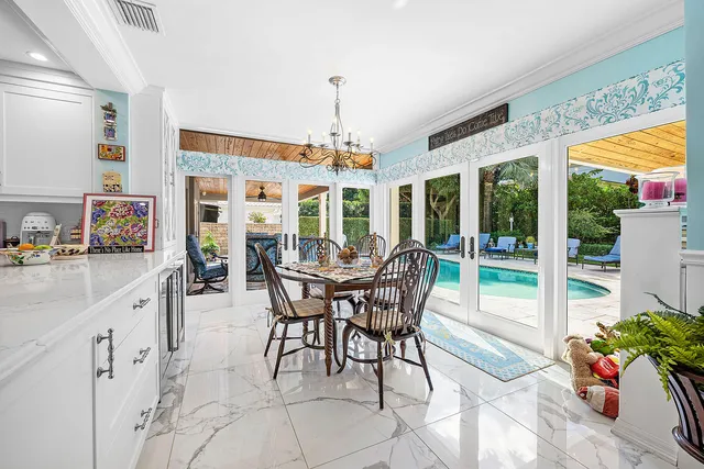 a view of a patio with a table chairs and a backyard
