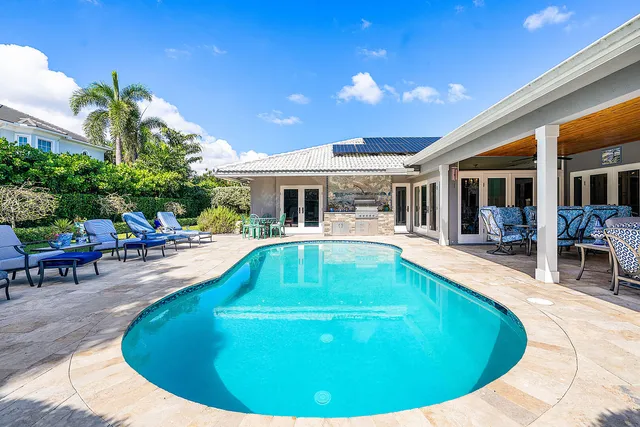 a view of a patio with a table chairs and backyard