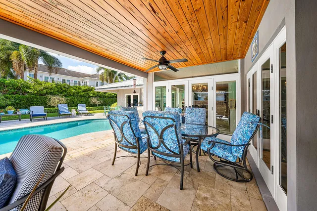 a view of a patio with a dining table and chairs under an umbrella