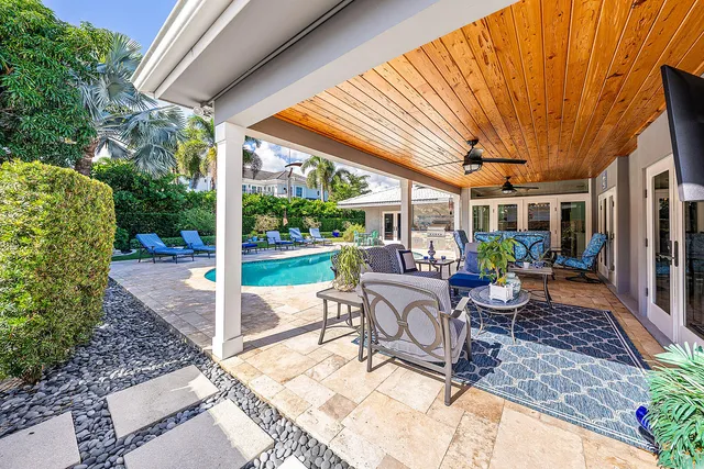 a view of a house with swimming pool and porch