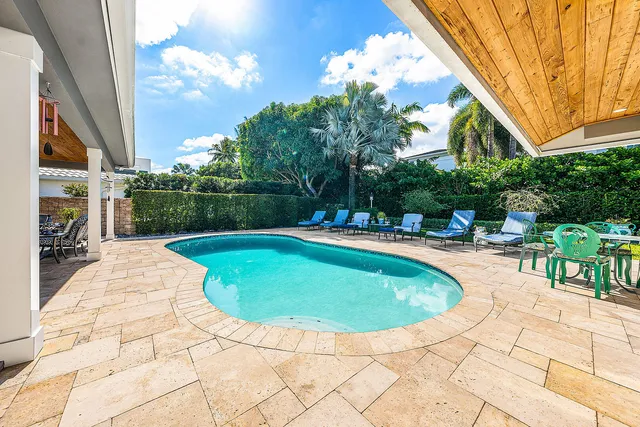 a view of a house with backyard porch and sitting area