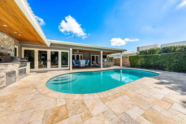 a aerial view of a house with swimming pool and sitting area
