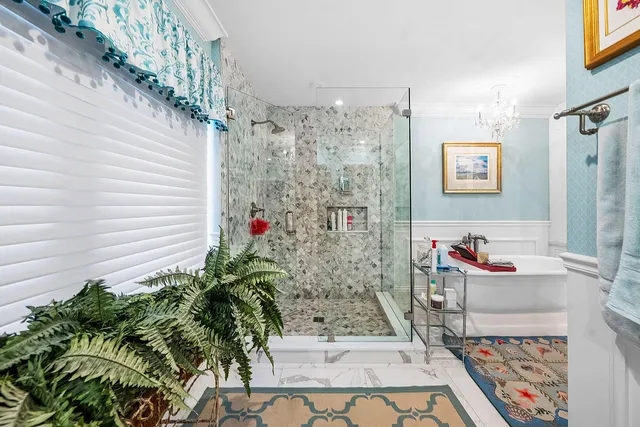 a living room with furniture a rug and a chandelier