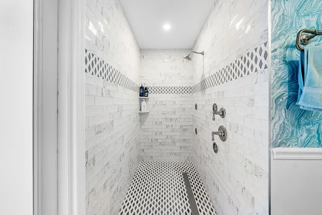 a view of a patio with table and chairs potted plants with floor to ceiling window
