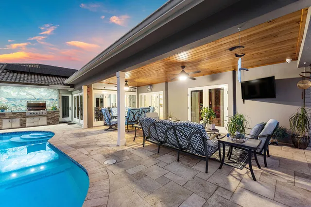 a view of a swimming pool with outdoor seating