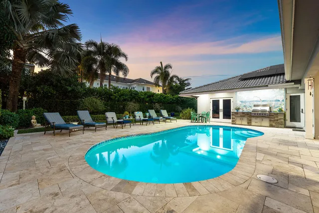 a view of a swimming pool with an outdoor seating