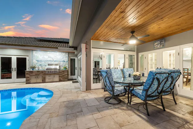 an aerial view of a house with swimming pool and a yard