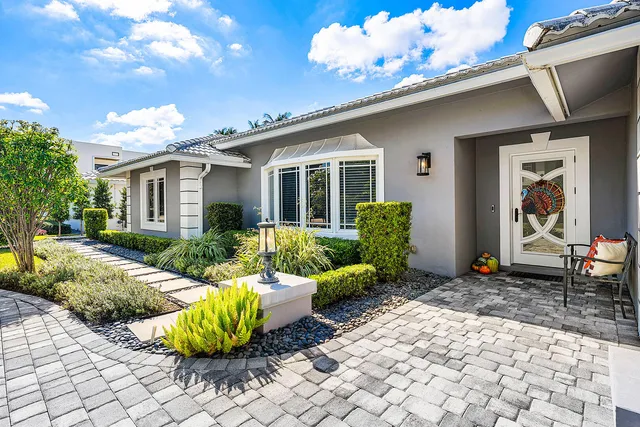 a living room with stainless steel appliances furniture wooden floor and a rug
