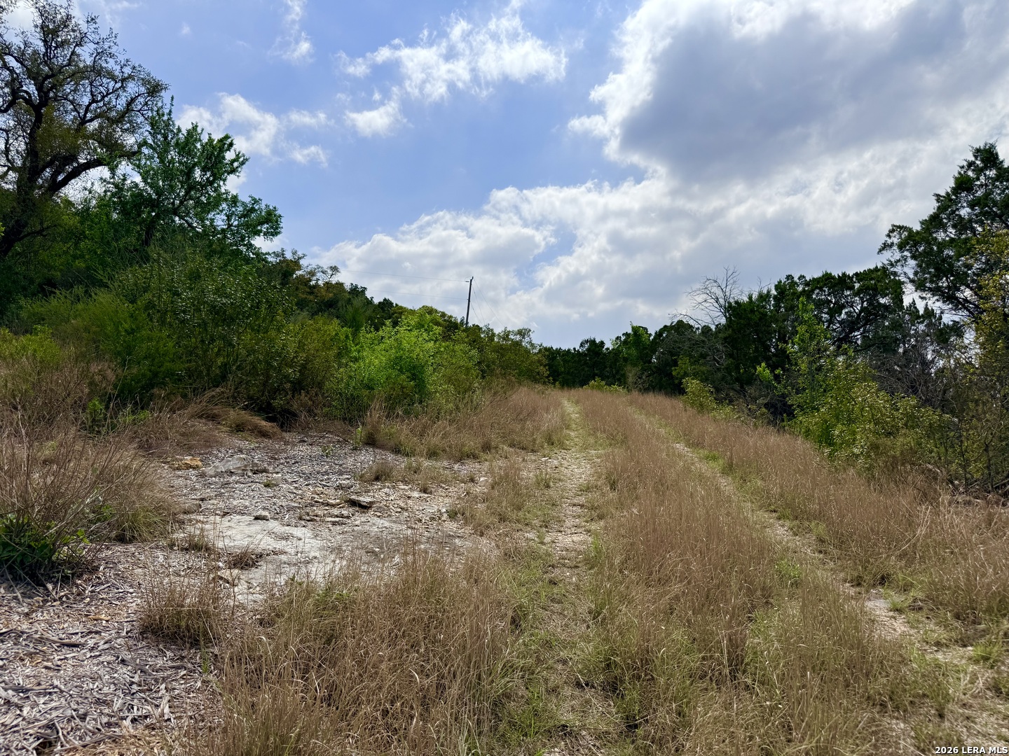 9852 Marnoch Road Helotes, TX 78023 - Photo 16 of 23 a view of a lake with houses in the back