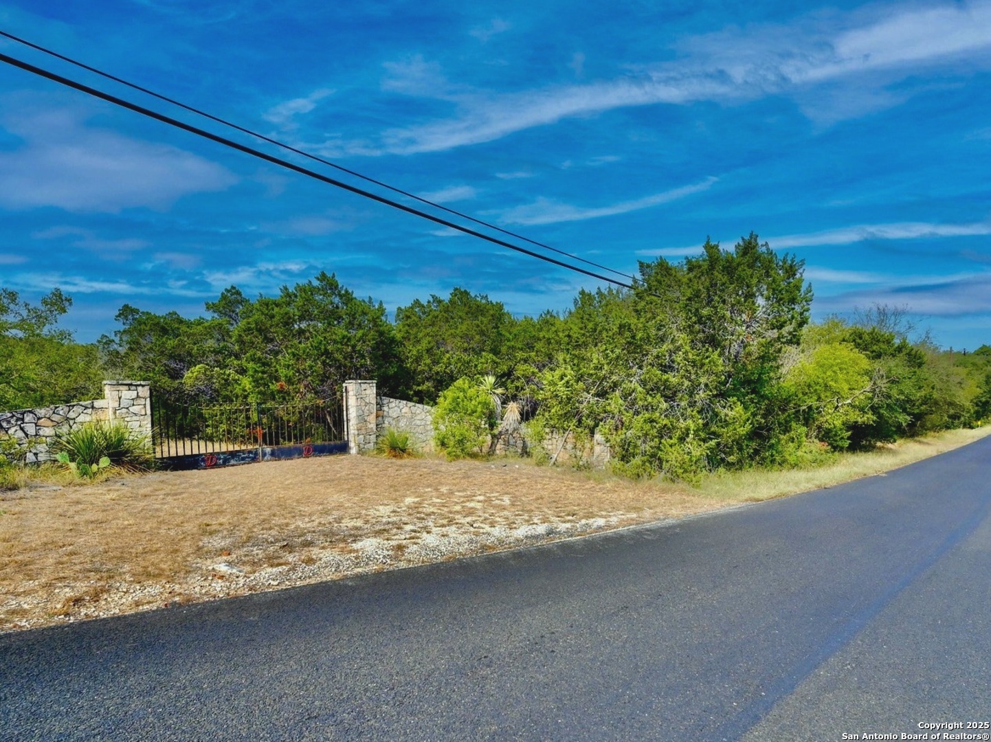 9852 Marnoch Road Helotes, TX 78023 - Photo 4 of 14 a view of a road with a building in the background