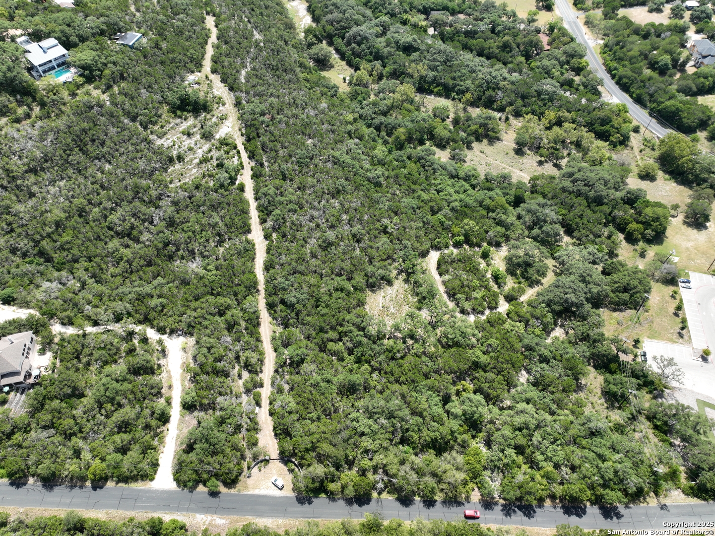 9852 Marnoch Road Helotes, TX 78023 - Photo 5 of 14 a view of a forest with a building