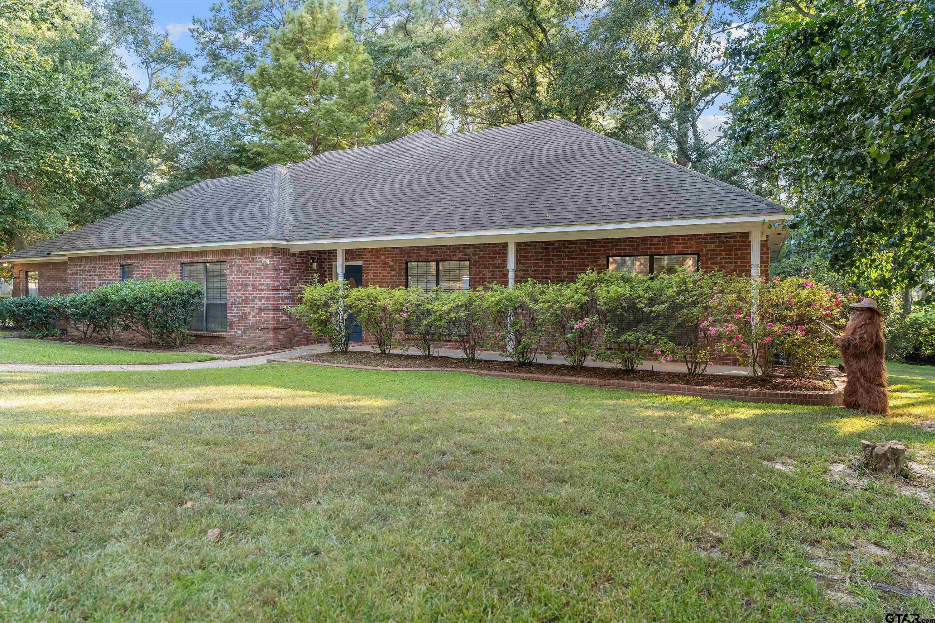 9211 Elm Tree Circle Tyler, TX 75703 - Photo 1 of 31 a front view of house with yard and green space