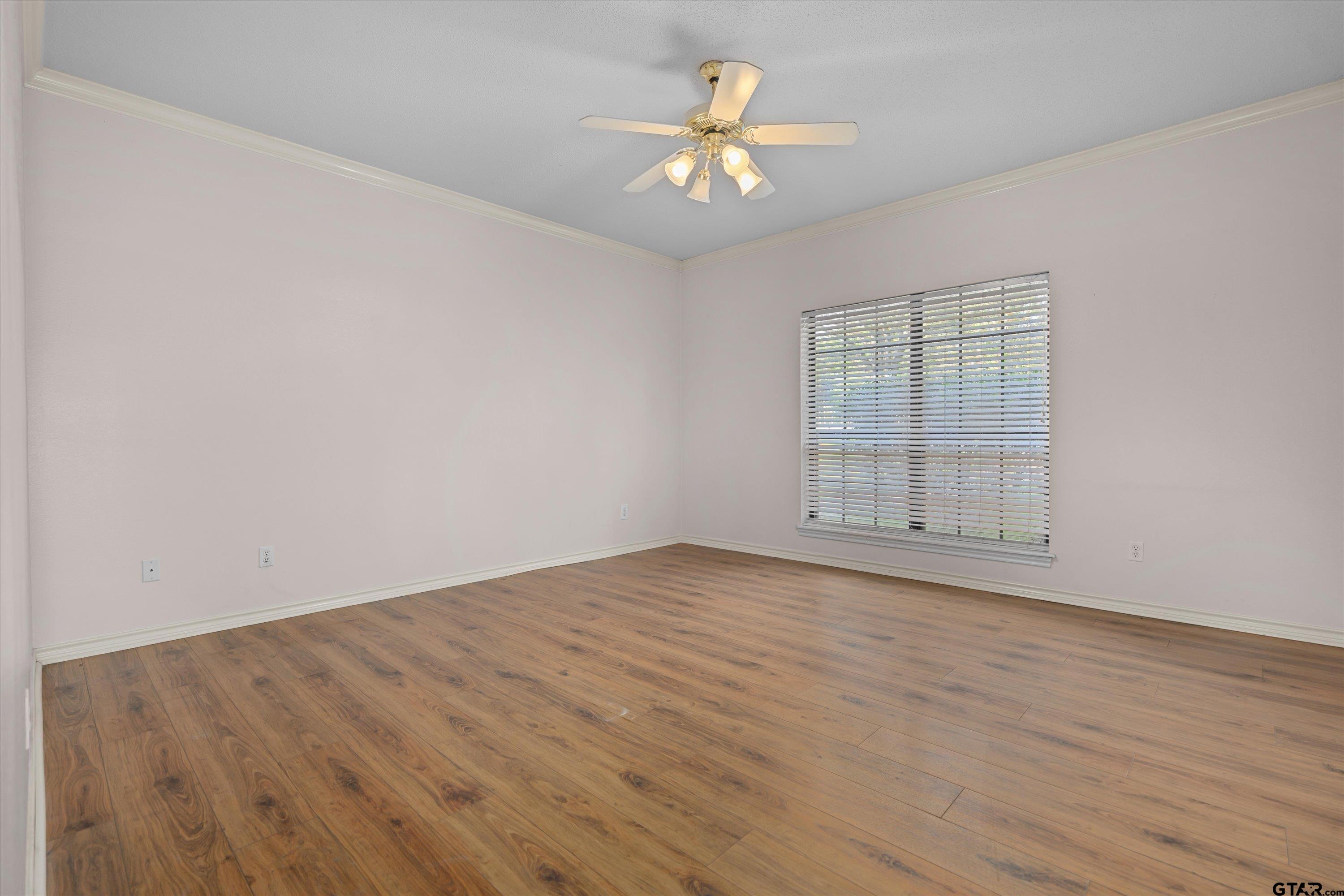 9211 Elm Tree Circle Tyler, TX 75703 - Photo 11 of 31 an empty room with wooden floor and windows