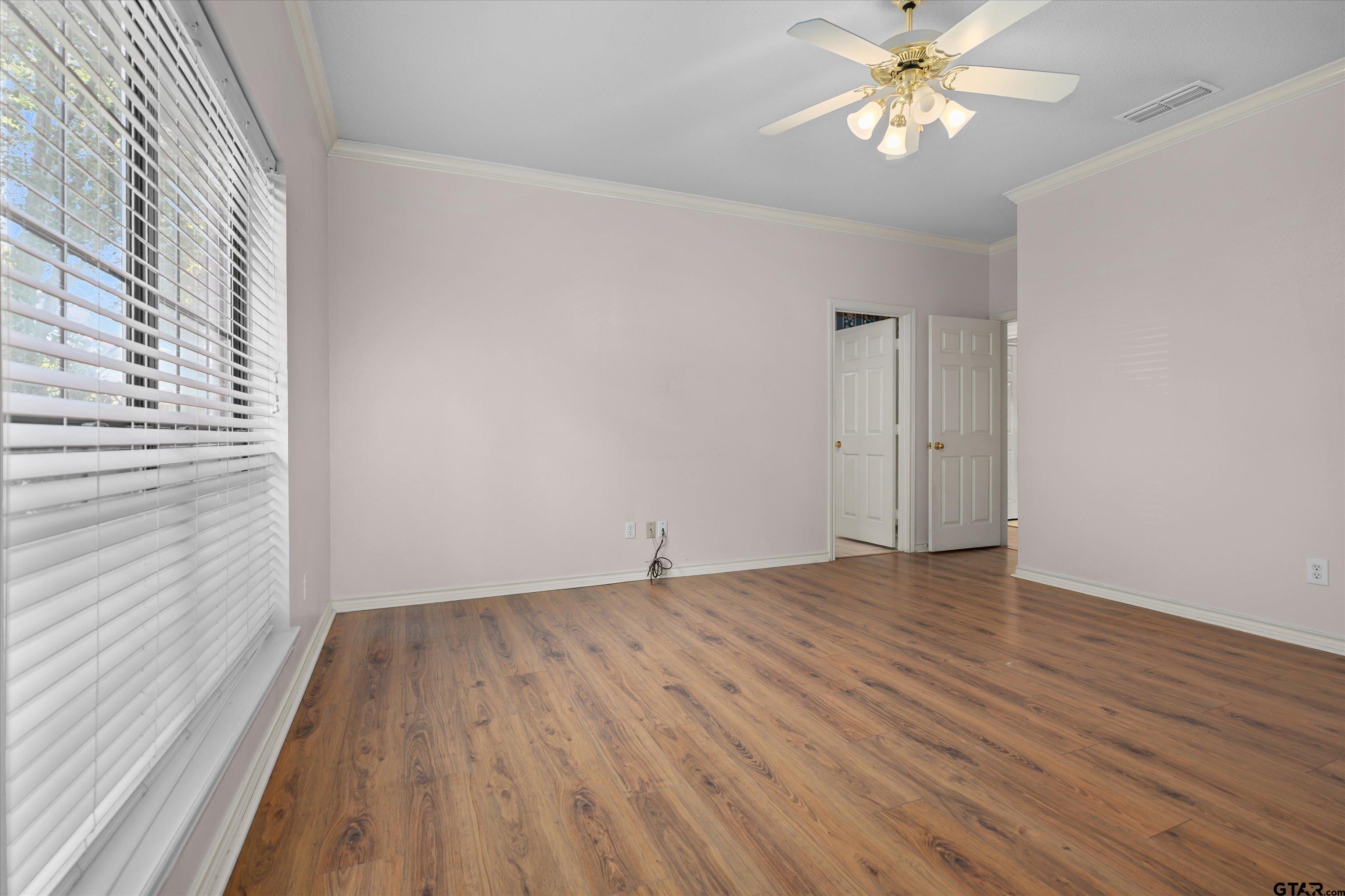 9211 Elm Tree Circle Tyler, TX 75703 - Photo 12 of 31 wooden floor in an empty room with a window