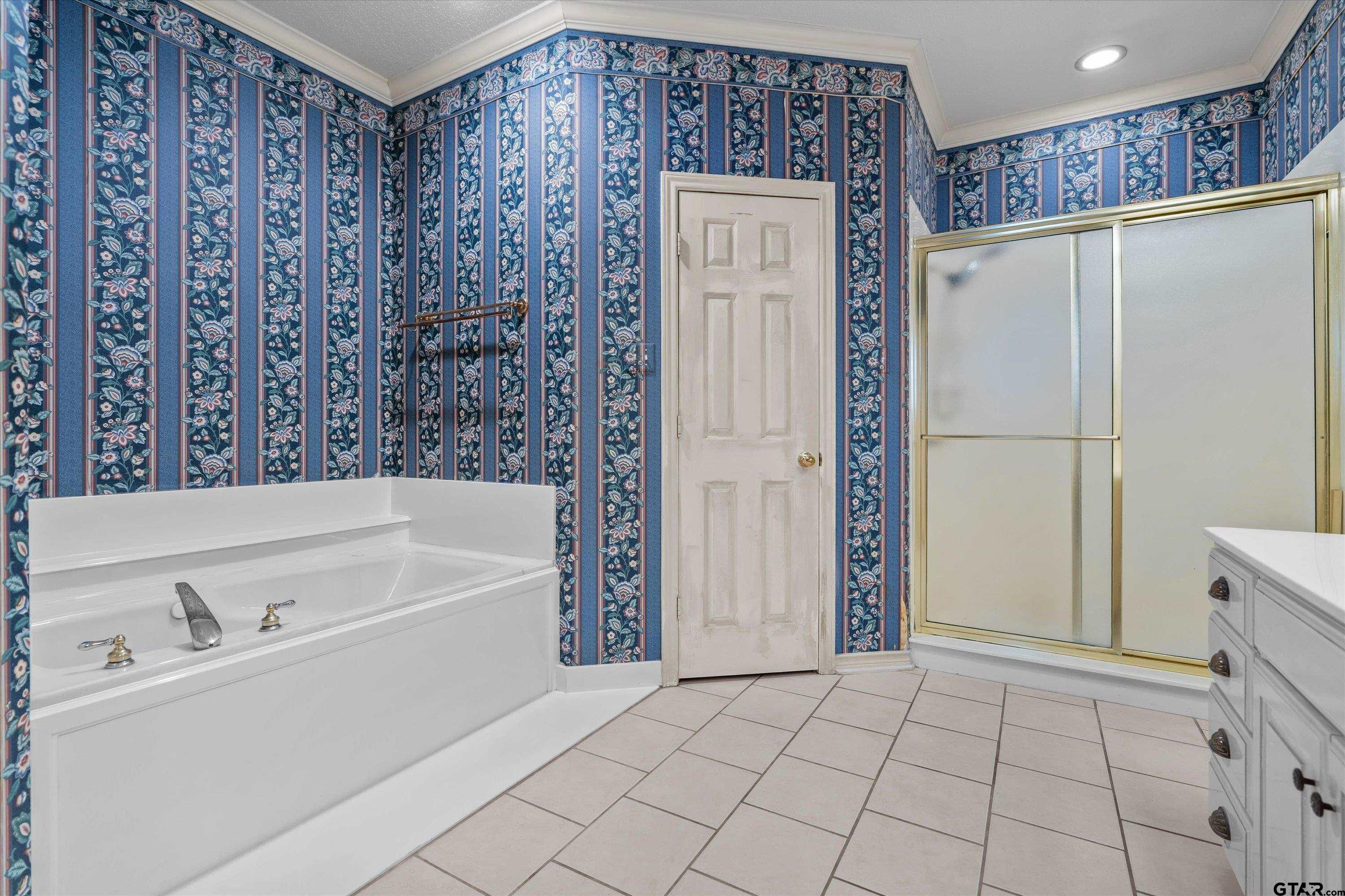9211 Elm Tree Circle Tyler, TX 75703 - Photo 14 of 31 a bathroom with a bathtub and a shower