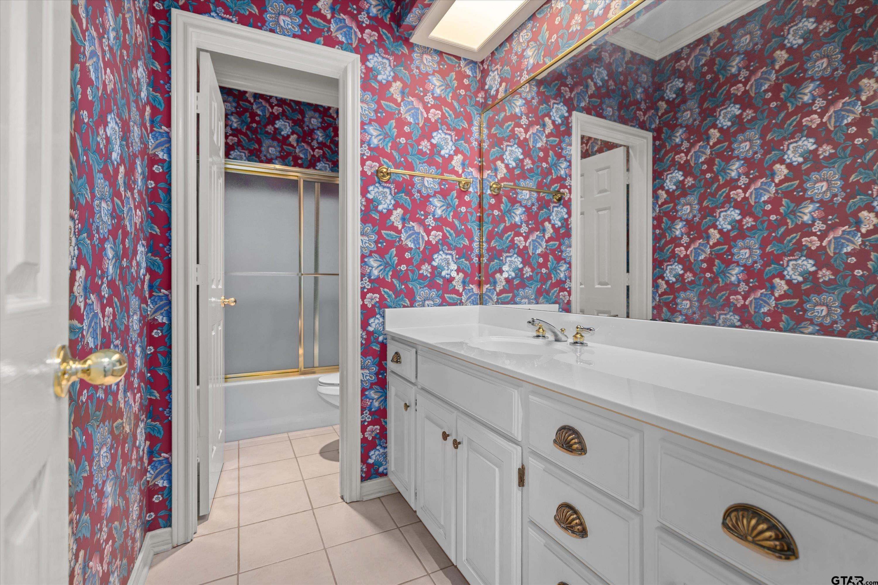 9211 Elm Tree Circle Tyler, TX 75703 - Photo 18 of 31 a bathroom with a sink and a mirror