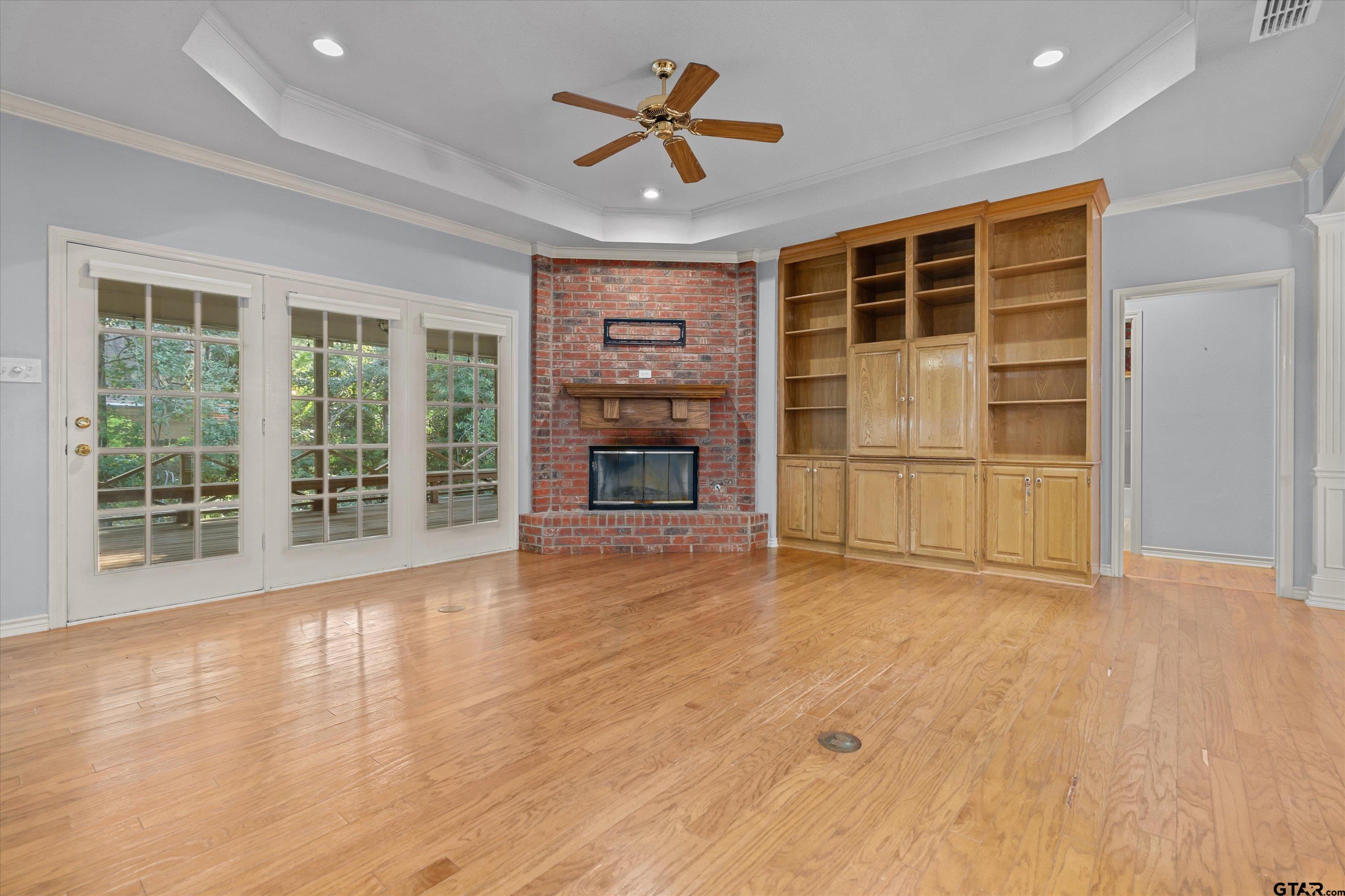9211 Elm Tree Circle Tyler, TX 75703 - Photo 2 of 31 a view of an empty room with a fireplace and a window