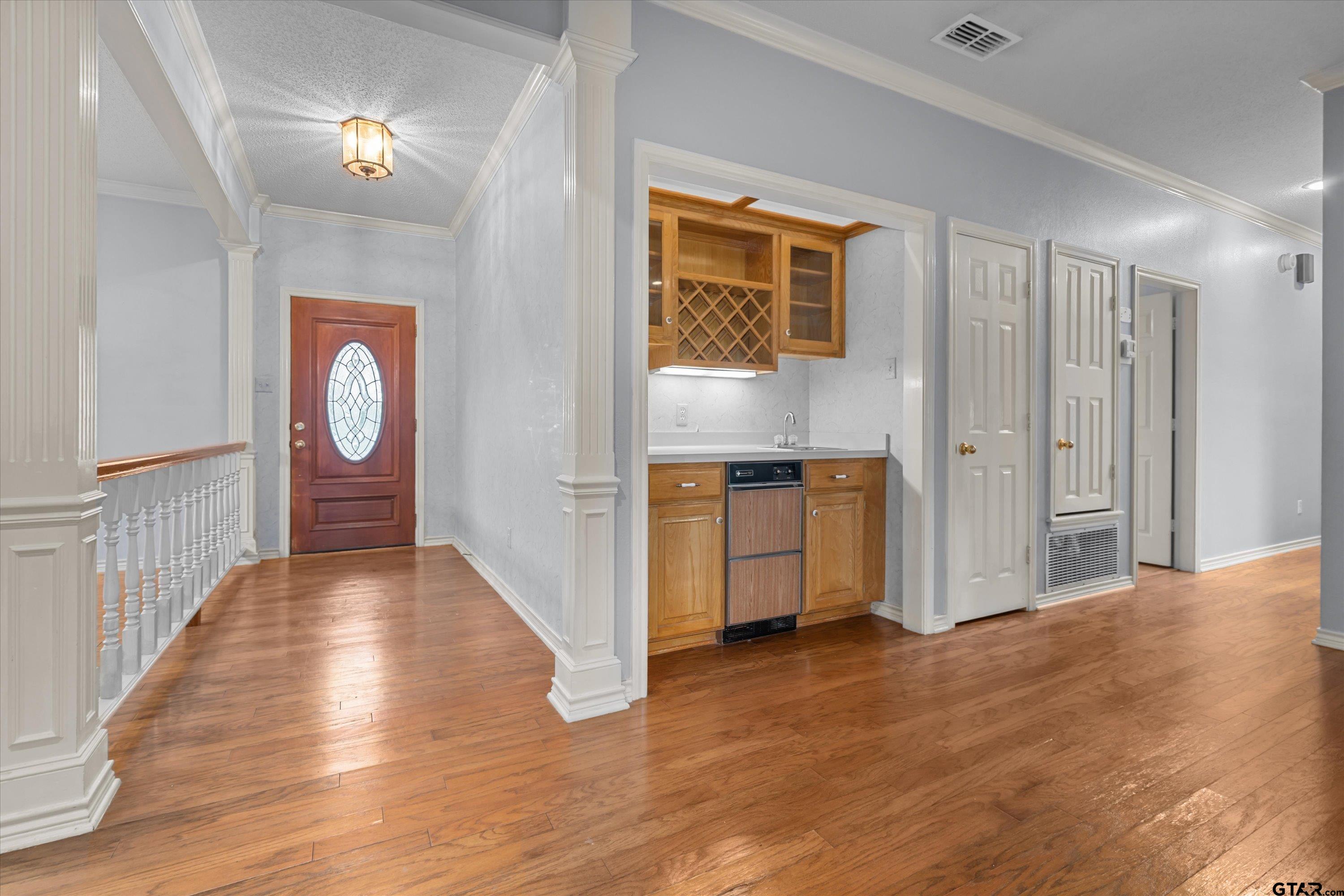 9211 Elm Tree Circle Tyler, TX 75703 - Photo 4 of 31 a view of a hallway with wooden floor and a bathroom