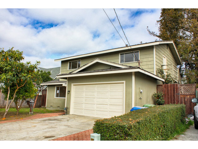 3283 Axford Road Santa Cruz, CA 95062 - Photo 1 of 15 a front view of a house with a yard and garage