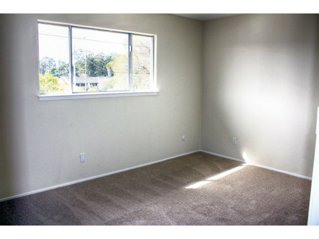 3283 Axford Road Santa Cruz, CA 95062 - Photo 11 of 15 an empty room with wooden floor and windows