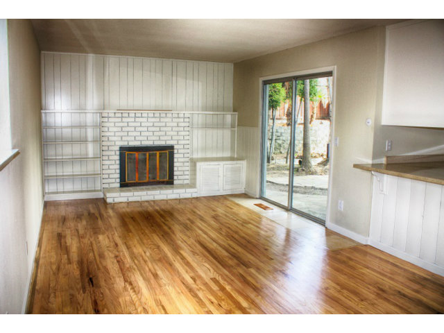 3283 Axford Road Santa Cruz, CA 95062 - Photo 4 of 15 a view of empty room with wooden floor and fireplace
