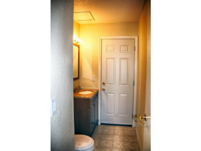 3283 Axford Road Santa Cruz, CA 95062 - Photo 5 of 15 a bathroom with a granite countertop sink a toilet and a shower