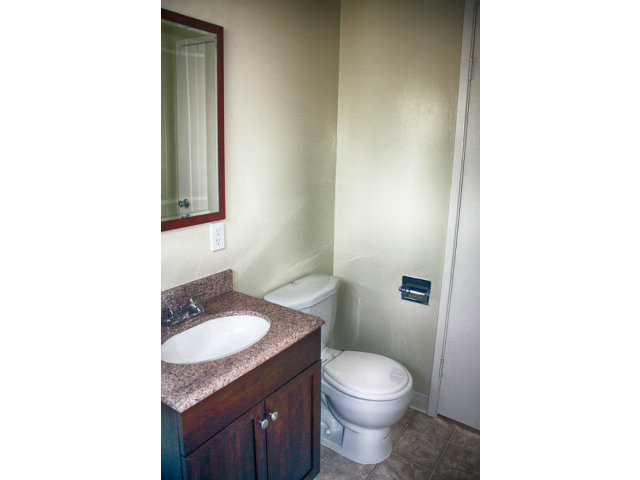 3283 Axford Road Santa Cruz, CA 95062 - Photo 6 of 15 a bathroom with a granite countertop sink toilet and mirror