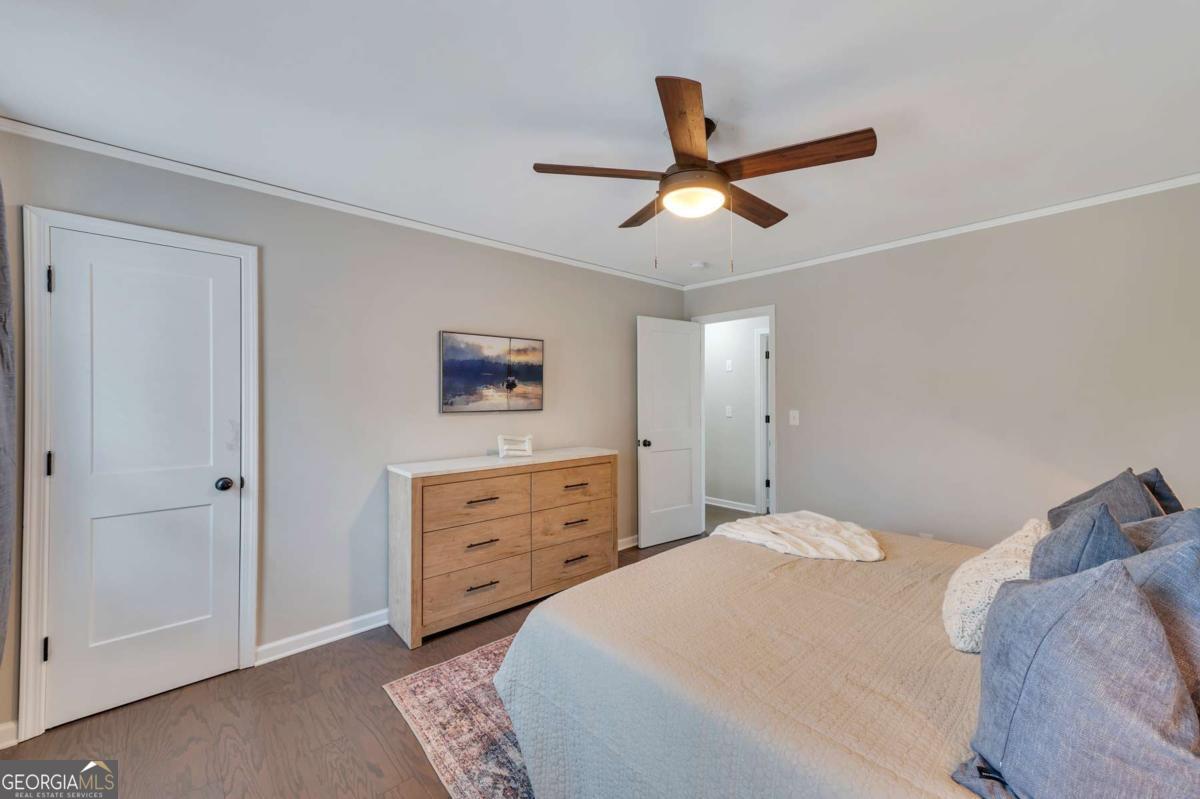 6805 Wright Road Northeast Atlanta, GA 30328 - Photo 12 of 28 a bedroom with a bed and a ceiling fan