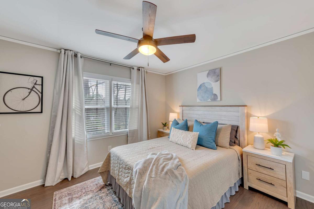 6805 Wright Road Northeast Atlanta, GA 30328 - Photo 13 of 28 a bedroom with a bed and a window