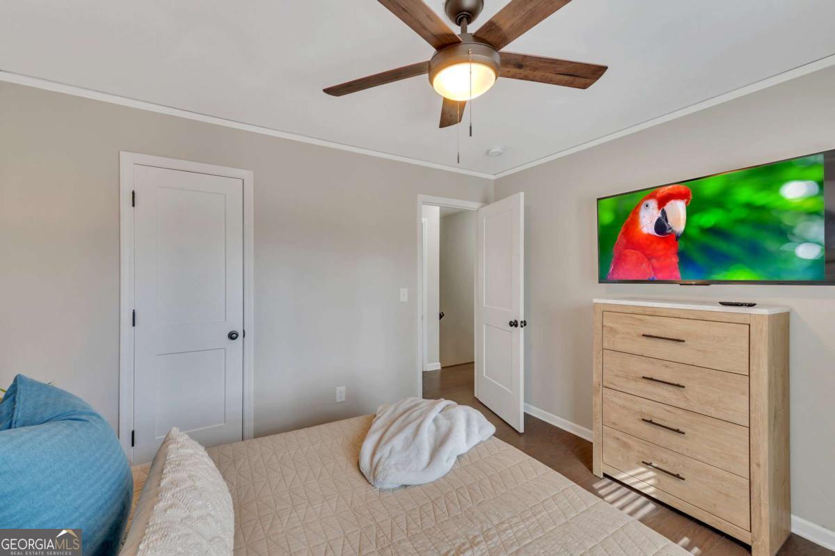 6805 Wright Road Northeast Atlanta, GA 30328 - Photo 14 of 28 a bedroom with a bed and a television