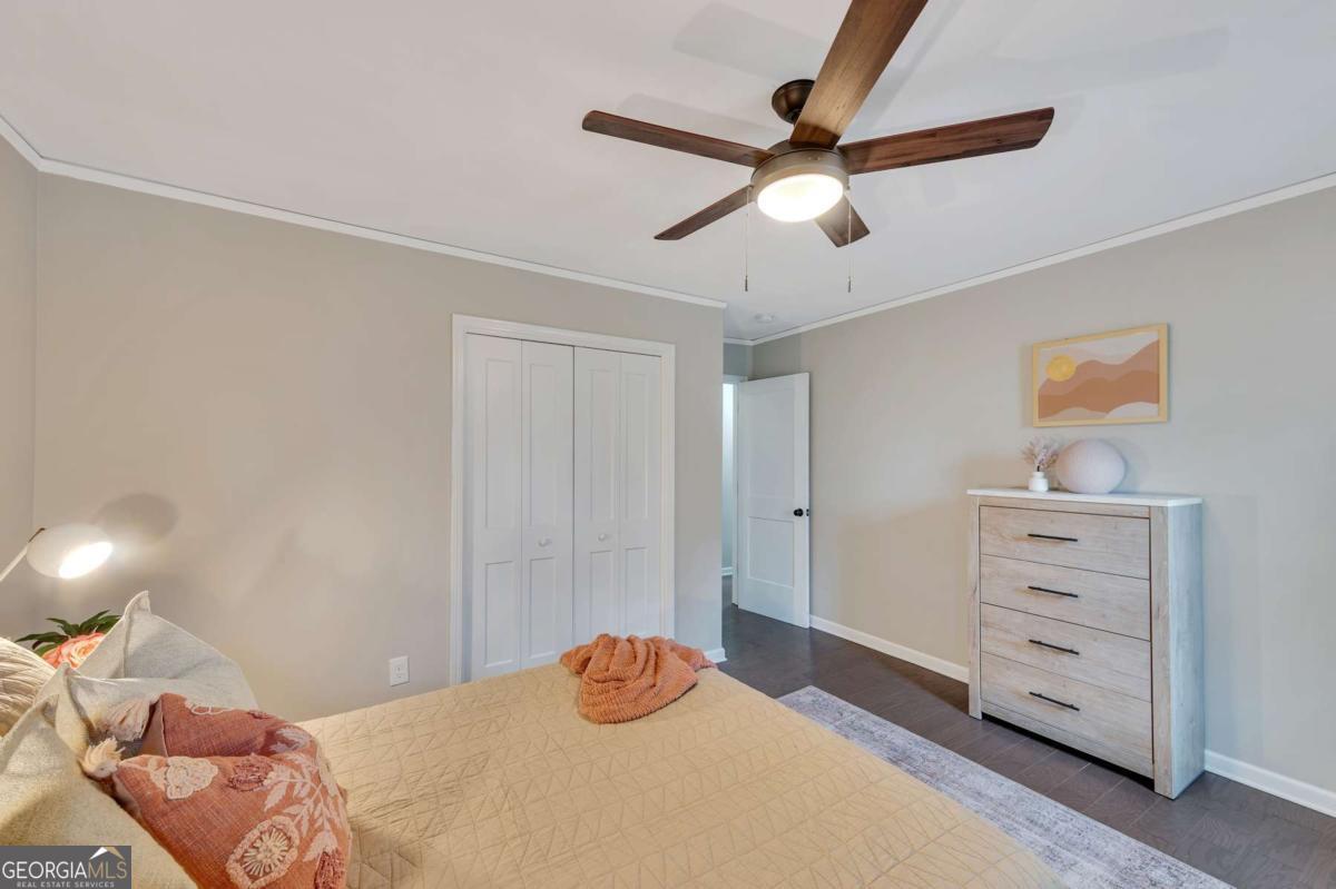 6805 Wright Road Northeast Atlanta, GA 30328 - Photo 17 of 28 a bedroom with a bed and a ceiling fan