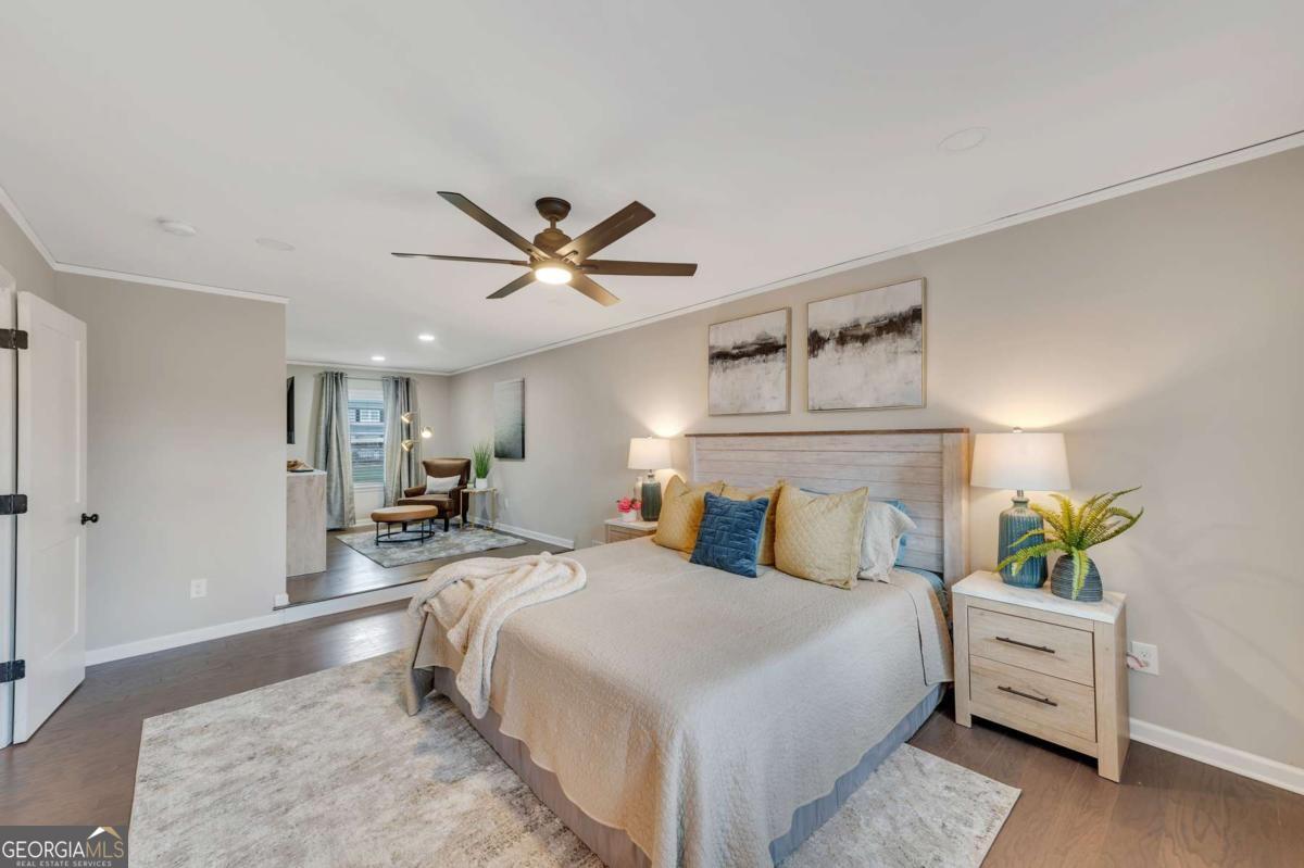 6805 Wright Road Northeast Atlanta, GA 30328 - Photo 18 of 28 a bedroom with a bed chandelier and a window