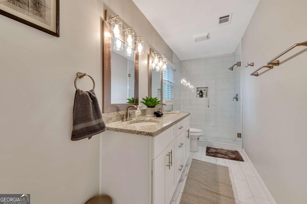 6805 Wright Road Northeast Atlanta, GA 30328 - Photo 21 of 28 a bathroom with a sink and mirror