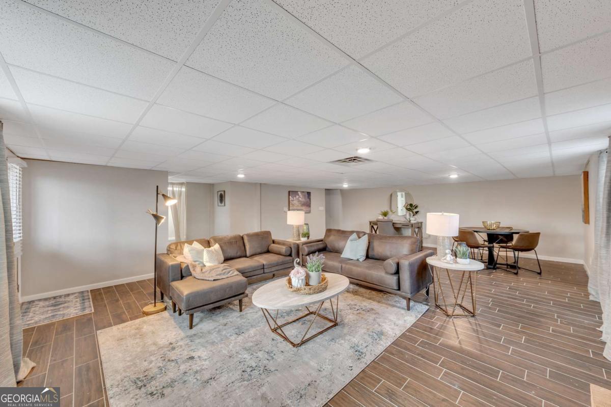 6805 Wright Road Northeast Atlanta, GA 30328 - Photo 24 of 28 a living room with lots of furniture and view of kitchen