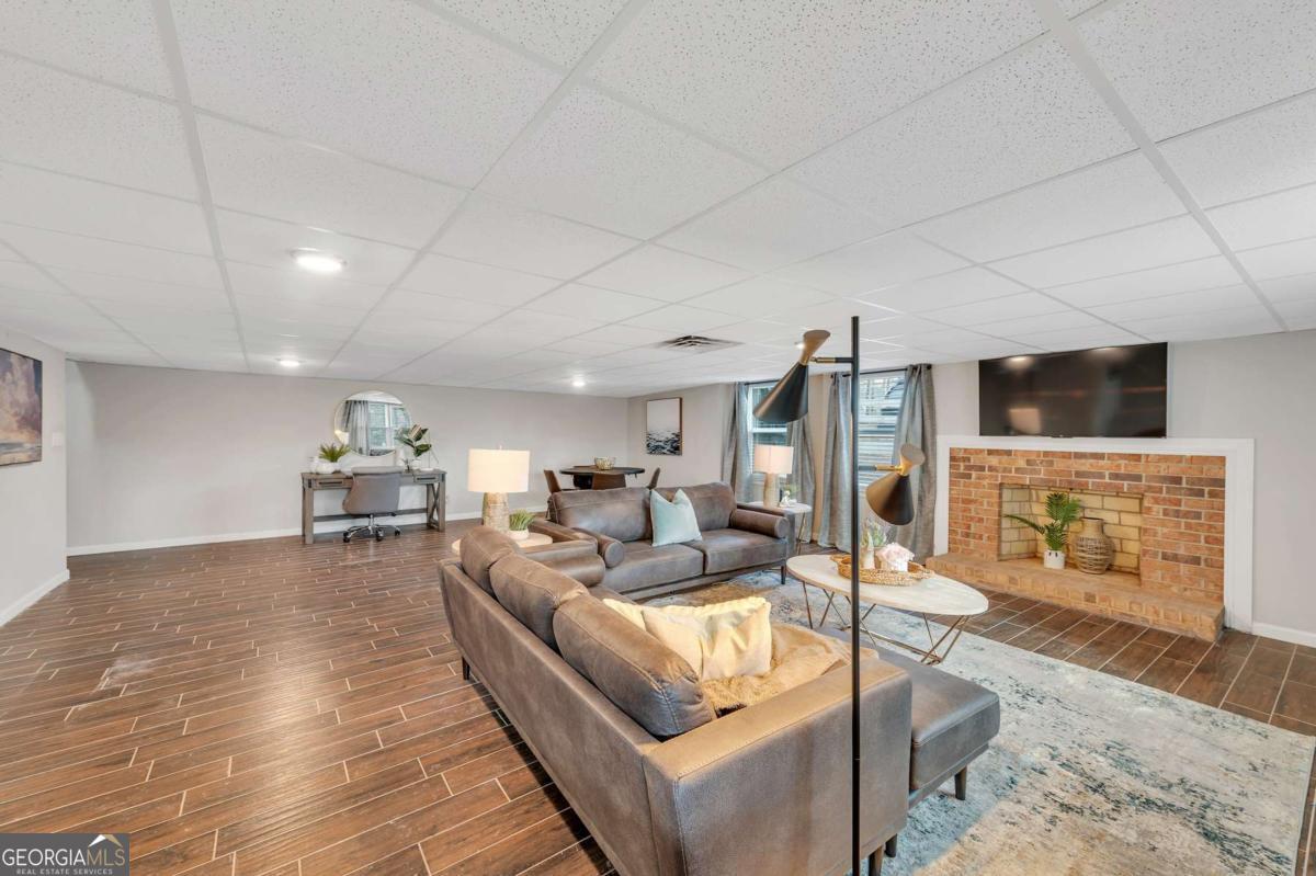 6805 Wright Road Northeast Atlanta, GA 30328 - Photo 25 of 28 a living room with furniture and a flat screen tv