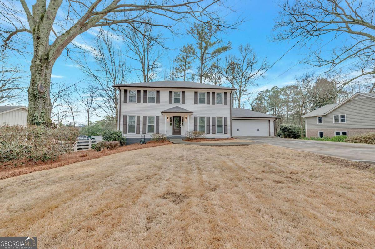 6805 Wright Road Northeast Atlanta, GA 30328 - Photo 27 of 28 a front view of a house with a large trees