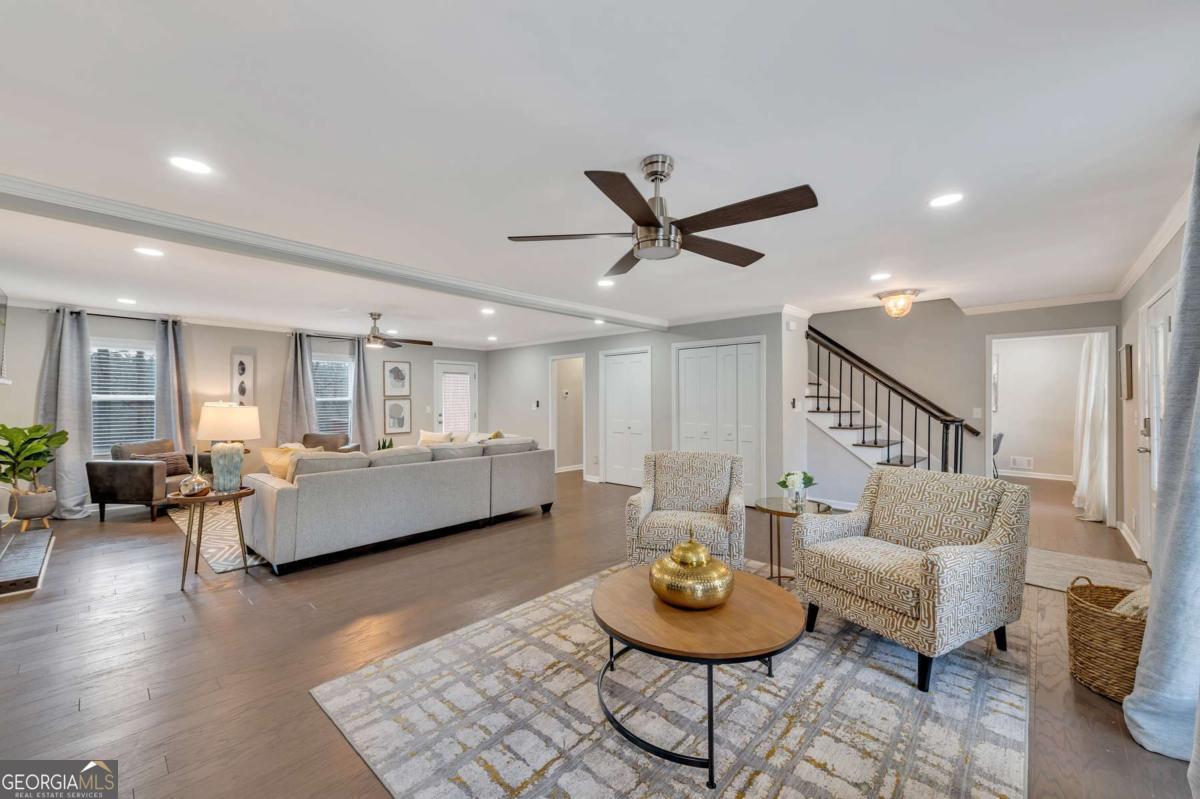 6805 Wright Road Northeast Atlanta, GA 30328 - Photo 3 of 28 a living room with furniture and a wooden floor