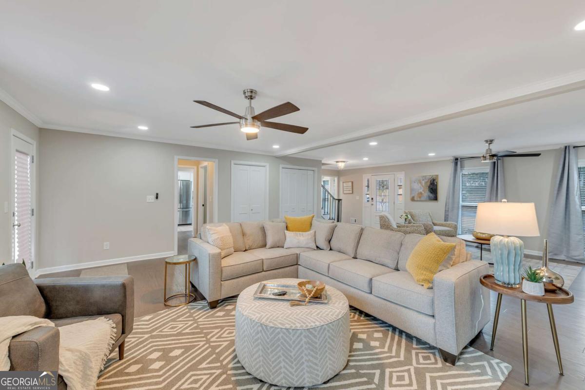 6805 Wright Road Northeast Atlanta, GA 30328 - Photo 5 of 28 a living room with furniture and a wooden floor