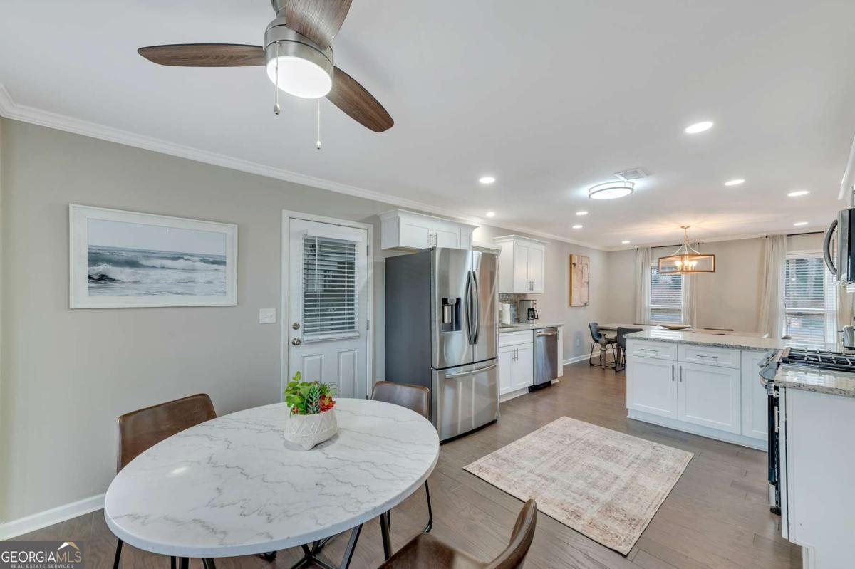 6805 Wright Road Northeast Atlanta, GA 30328 - Photo 7 of 28 a kitchen with refrigerator and windows