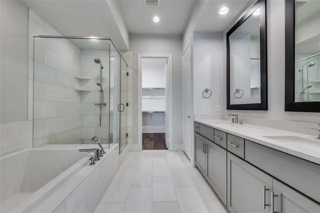 a spacious bathroom with a bathtub shower sink and mirror