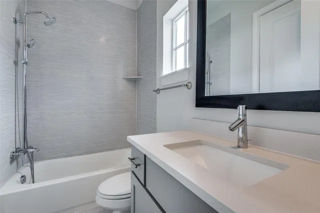 a bathroom with a sink a toilet and bathtub