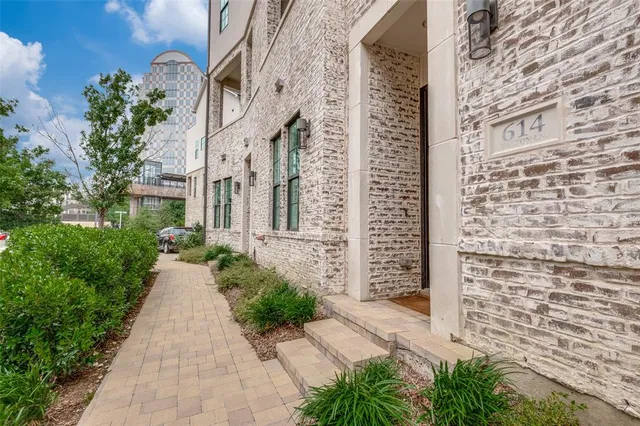 a pathway of a house with a yard