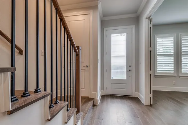 a view of a room with wooden floor and windows
