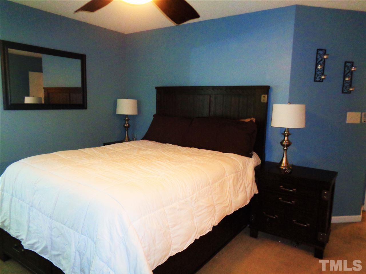 5304 Graymar Court Raleigh, NC 27616 - Photo 11 of 25 a bedroom with a bed and a dresser
