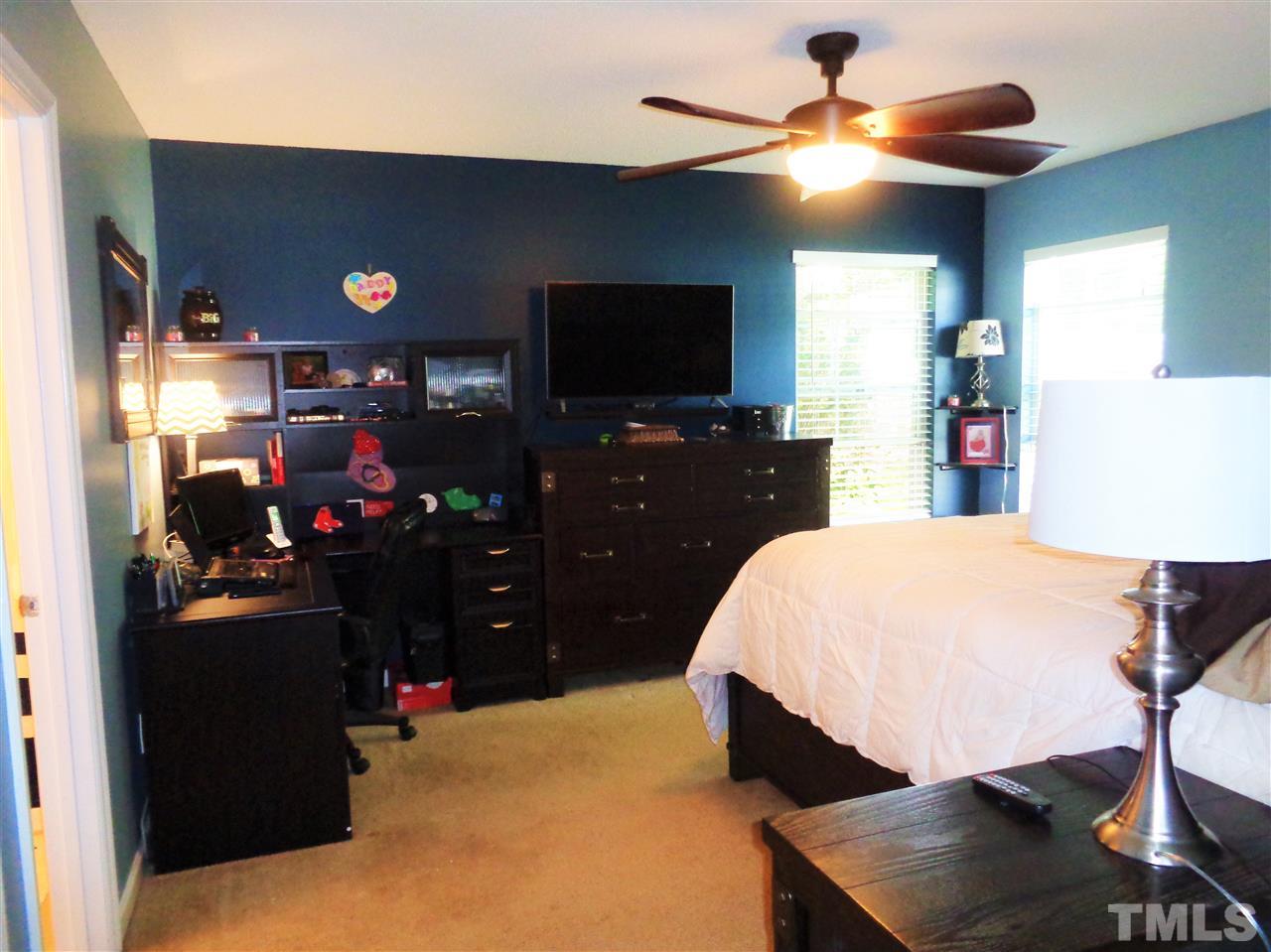 5304 Graymar Court Raleigh, NC 27616 - Photo 12 of 25 a bed room with a bed and a television