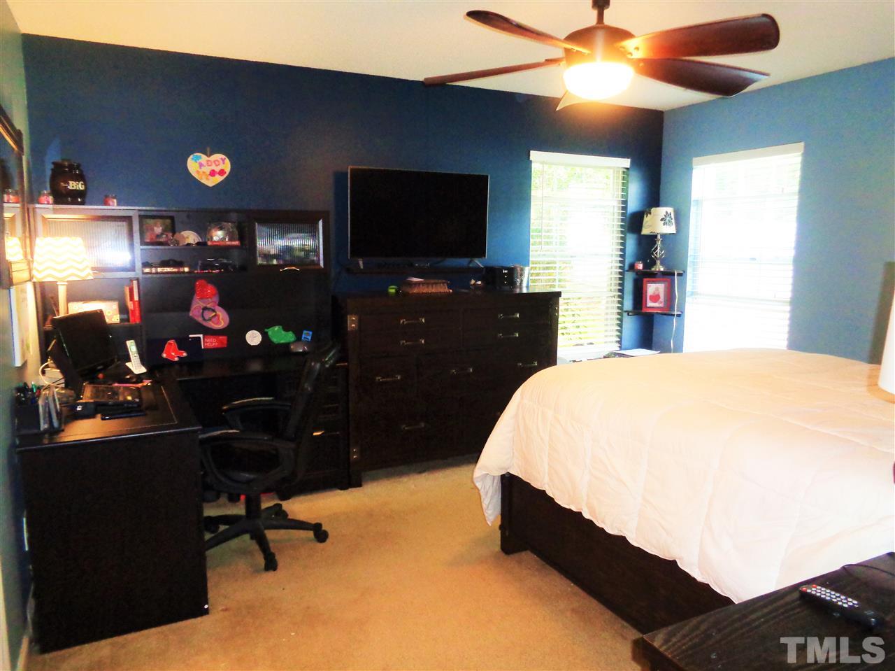 5304 Graymar Court Raleigh, NC 27616 - Photo 13 of 25 a bed room with a bed and a flat tv screen on dresser