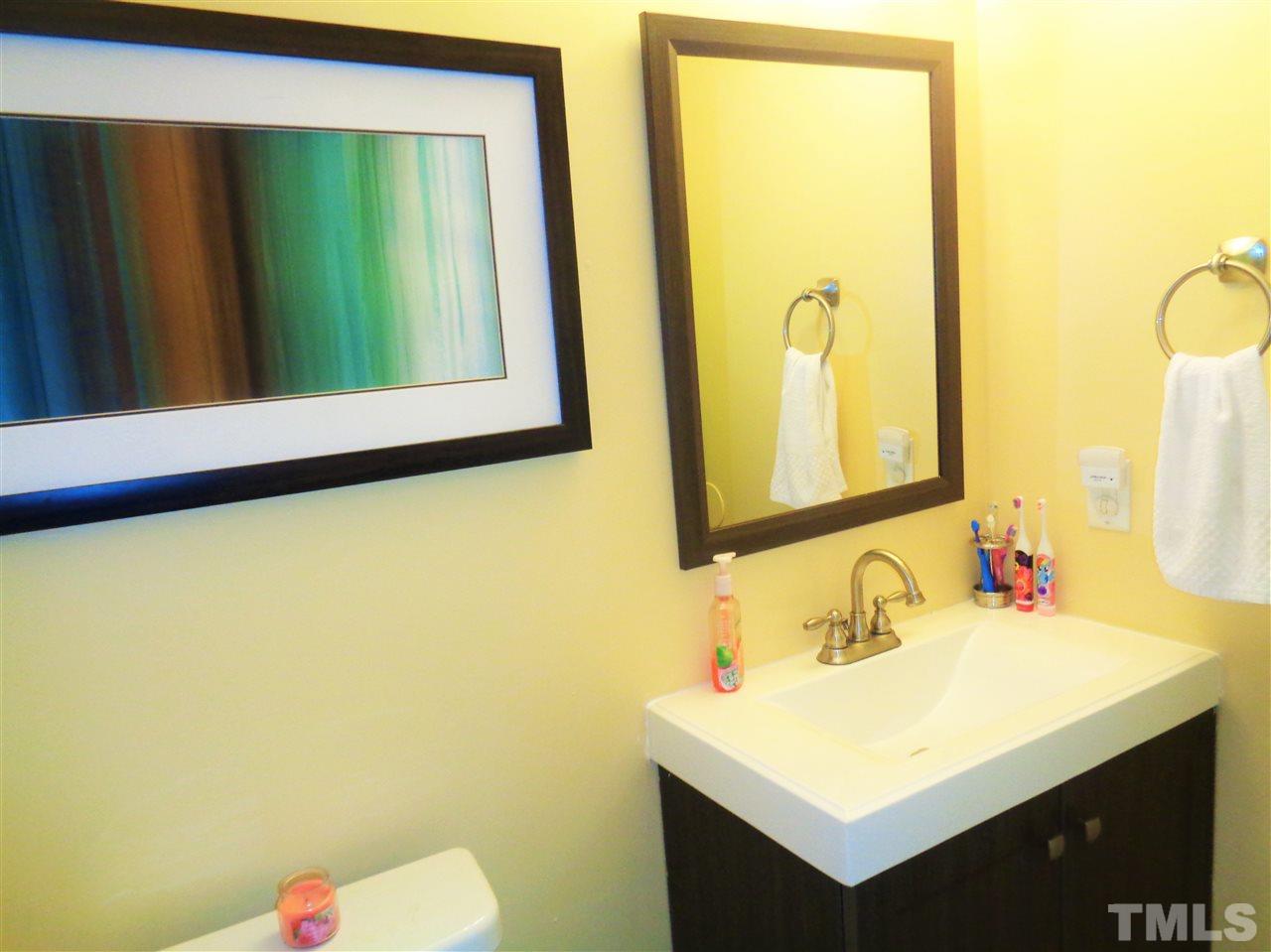 5304 Graymar Court Raleigh, NC 27616 - Photo 14 of 25 a bathroom with a sink vanity and a mirror