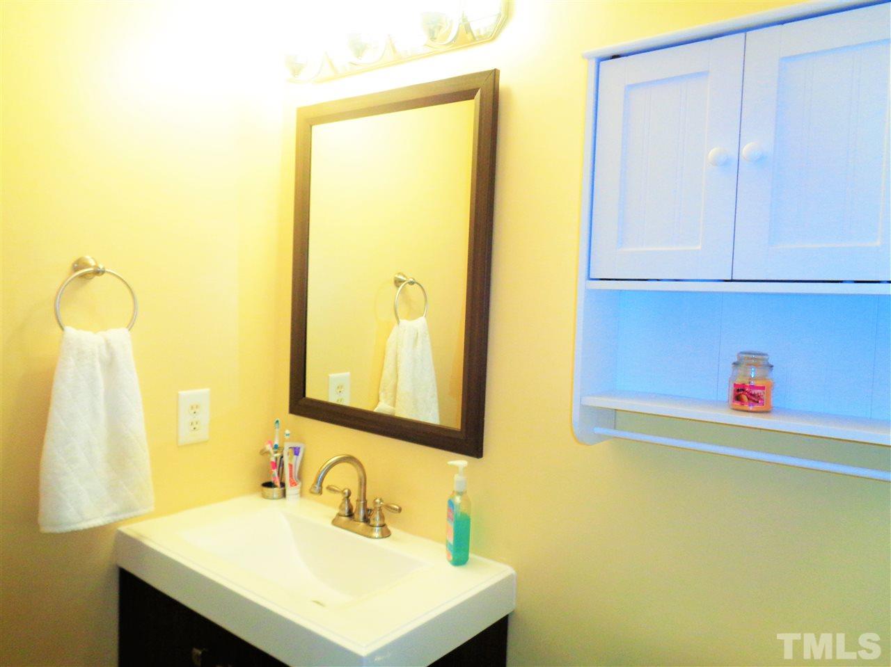 5304 Graymar Court Raleigh, NC 27616 - Photo 16 of 25 a bathroom with a sink and a mirror