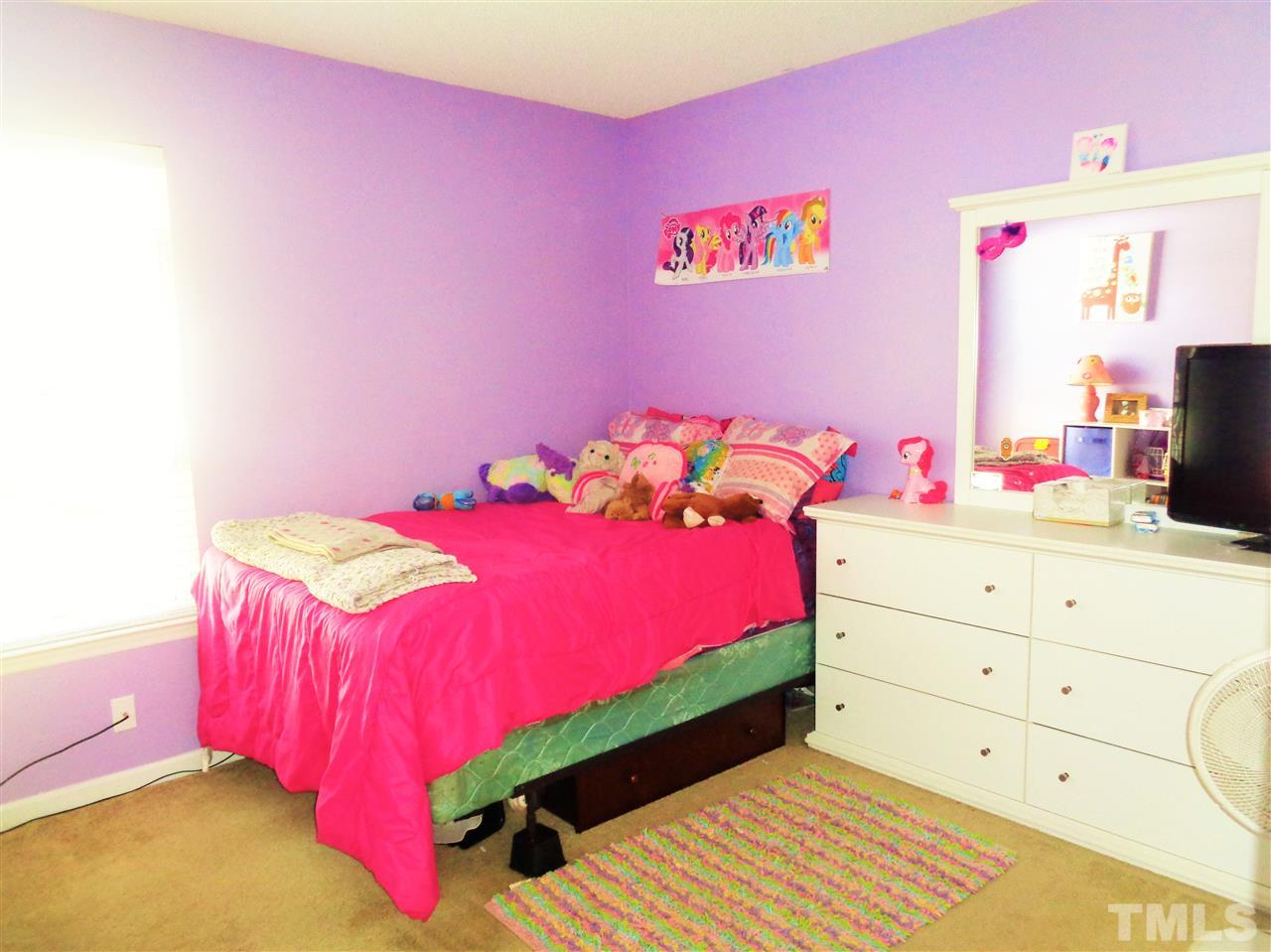5304 Graymar Court Raleigh, NC 27616 - Photo 17 of 25 a bedroom with a bed and a dresser in it